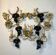 Large pair of wall sconces with vine decorations.