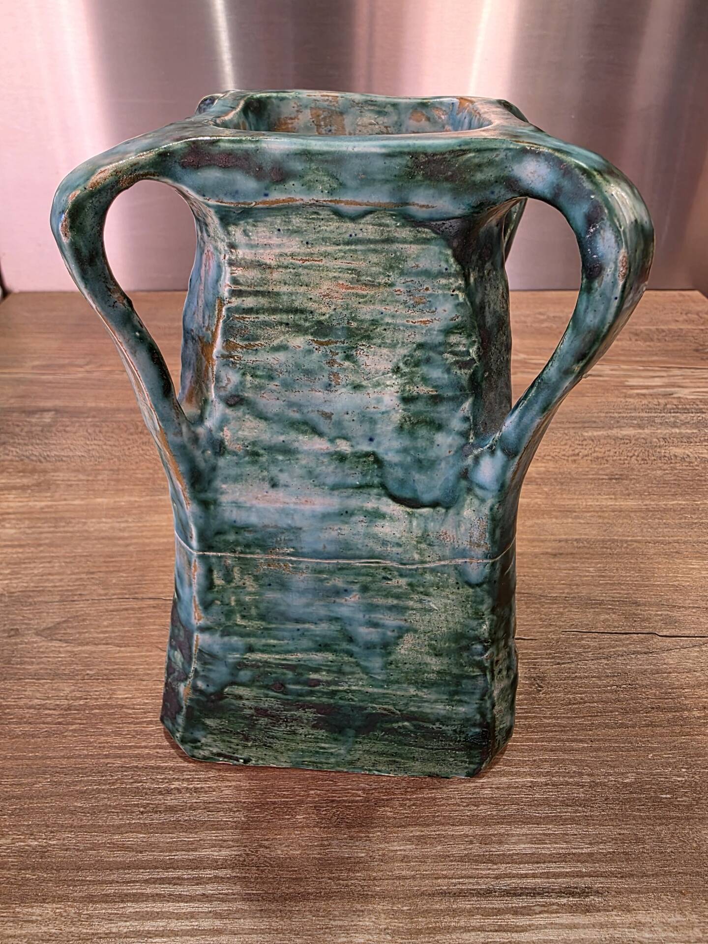 Vintage brutalist ceramic vase with 4 green handles.