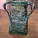 Vintage brutalist ceramic vase with 4 green handles.