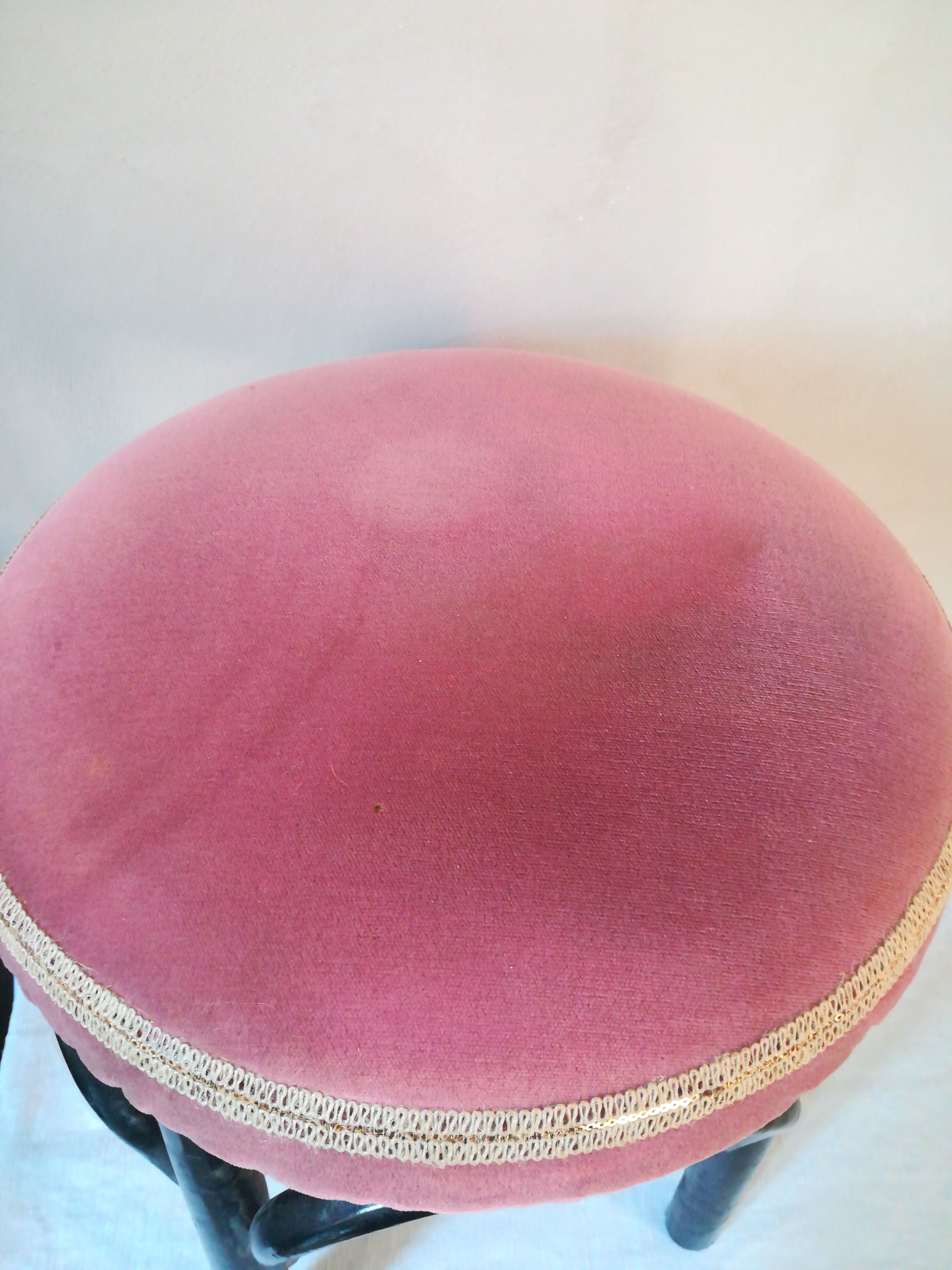 Black stool sitting in velvet rose