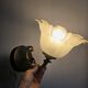 Frosted glass tulip wall sconces with brass arms.