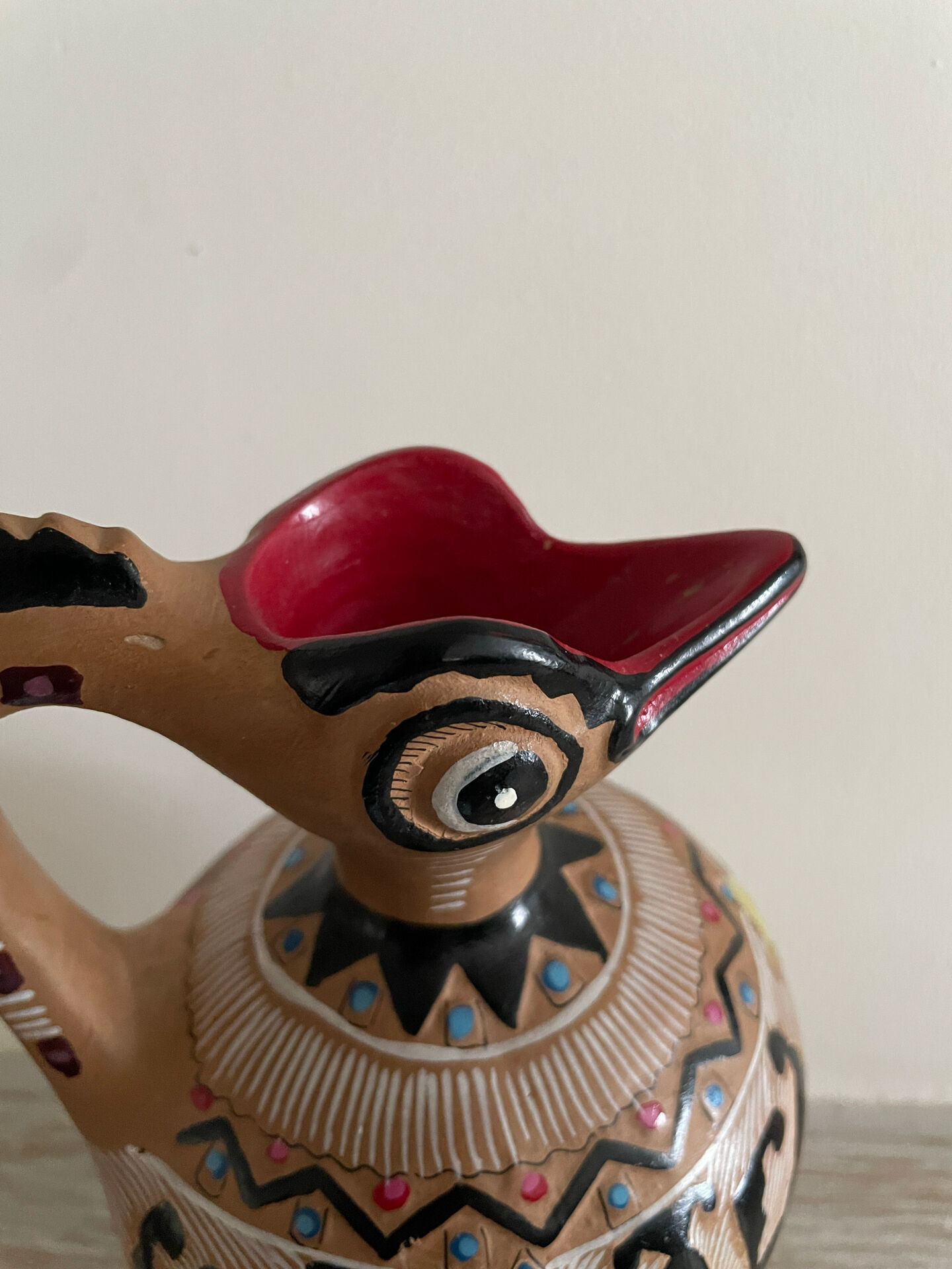 Clay pitcher with a bird head