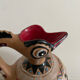 Clay pitcher with a bird head