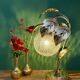 Vintage lamp with brass leaf design and transparent glass globe.