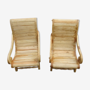 Two low teak armchairs