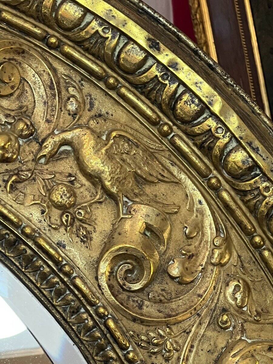 A. Arens, Antwerp, important oval mirror in repoussé brass with numerous animal decorations