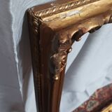 Old frame in wood and gilded stucco