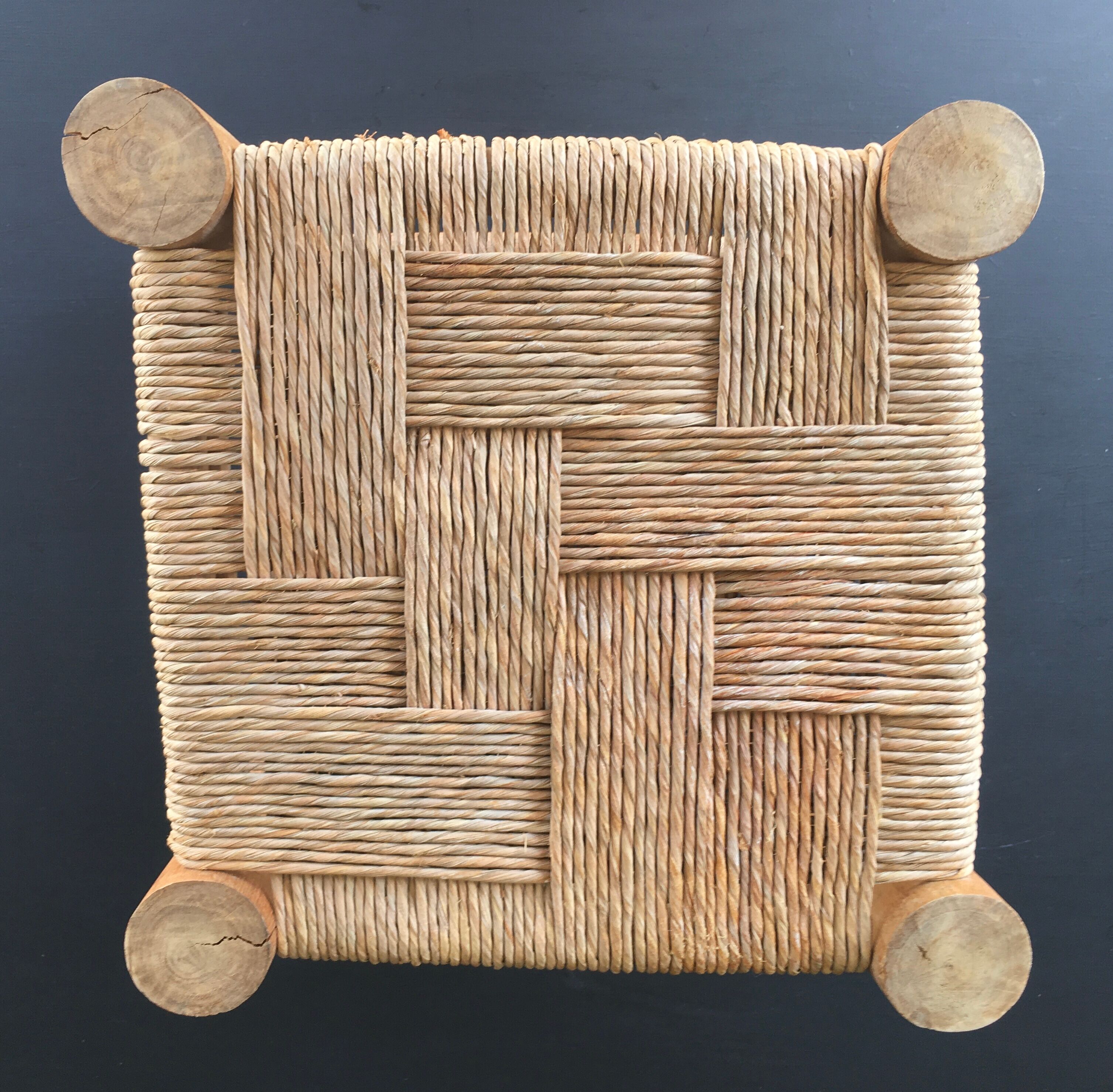 Wooden stool seated in braided rope