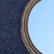 Paire de miroirs ovales en bois doré époque Louis Philippe