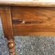 Antique cherry farmhouse table with turned legs and 2 drawers.