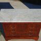 Antique mahogany chest of drawers with white marble.