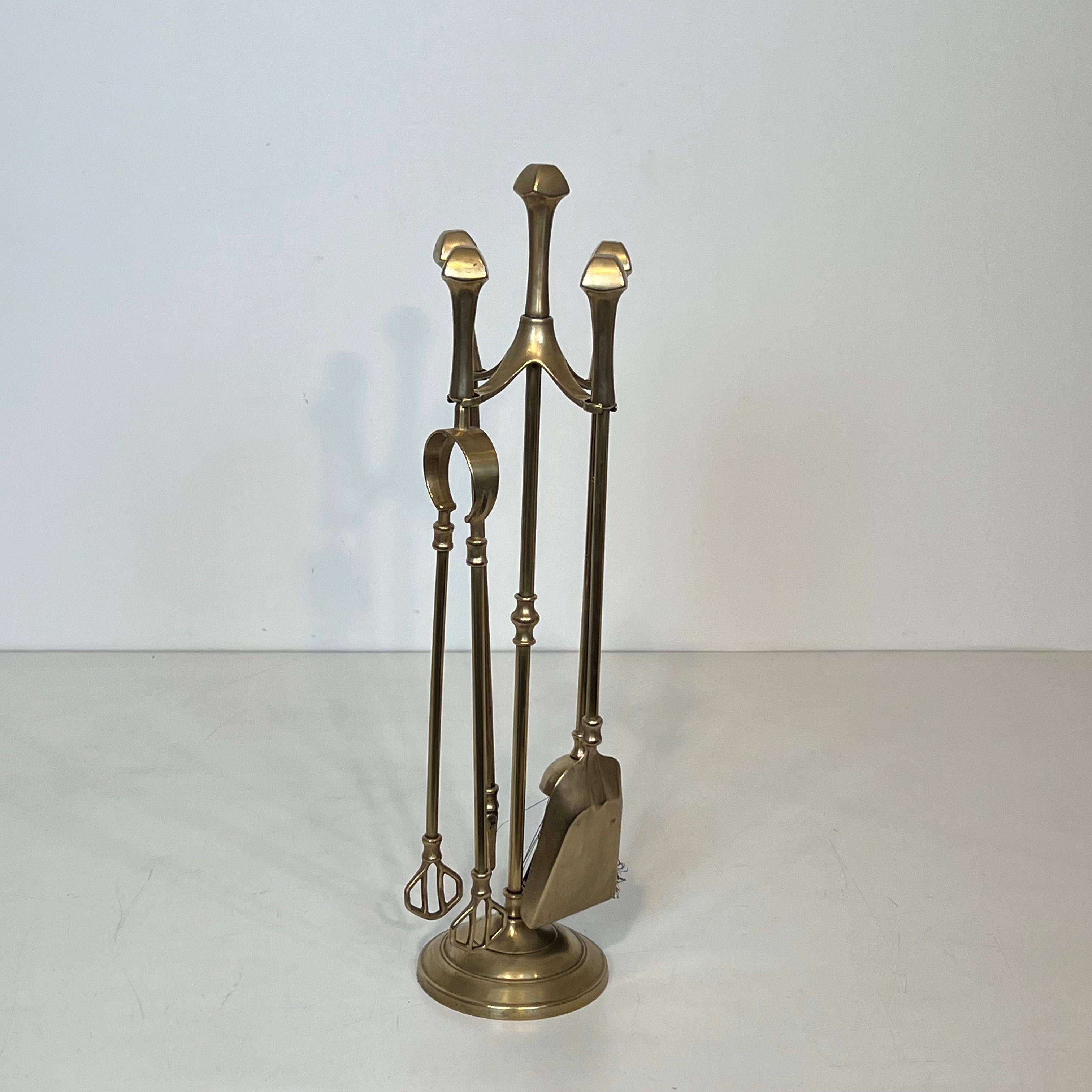 Neoclassical brass fire accessory.
