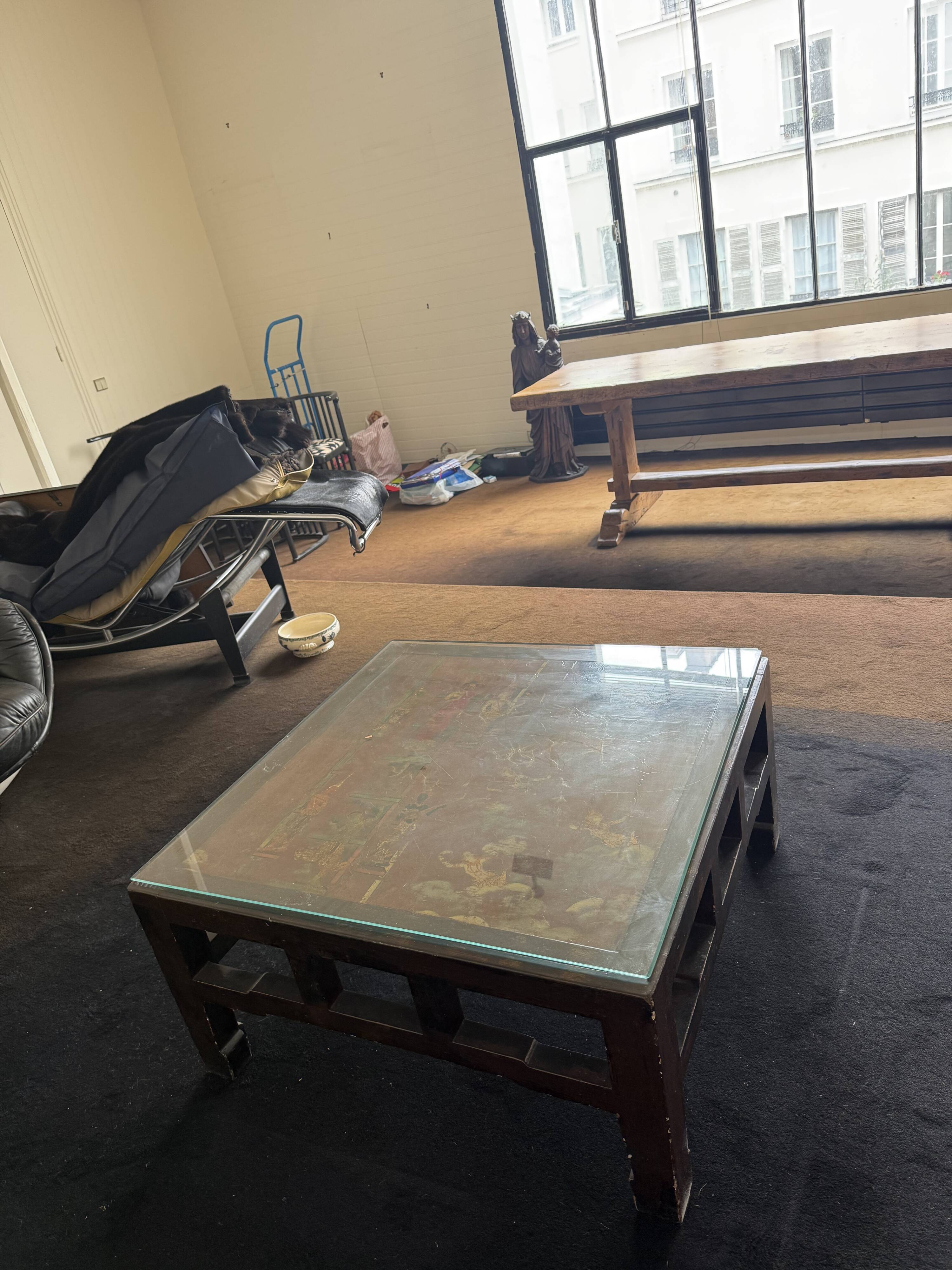 Vintage brutalist coffee table with Asian decor.