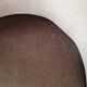 Brown velvet crapaud armchair with fringes and sculpted legs.