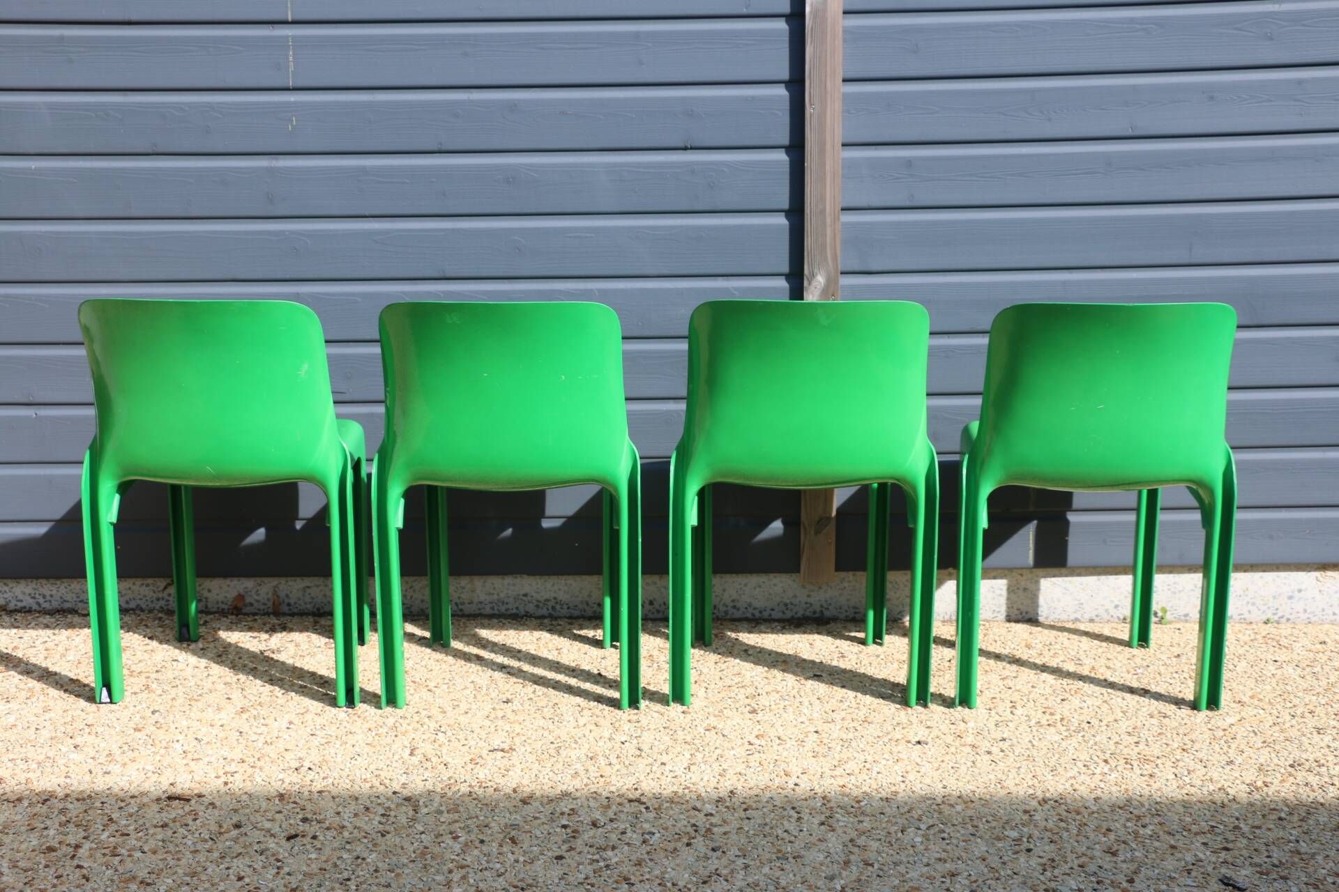 Set of 4 green Selene Magistretti chairs.
