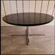 Blackened wooden dining table and chrome foot with integrated butterfly extension