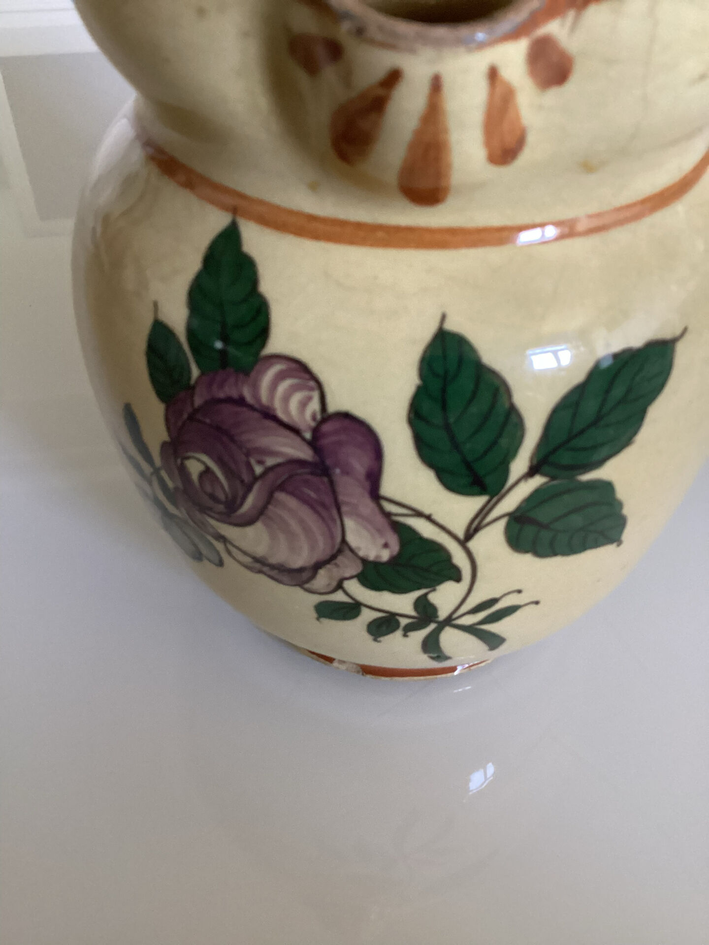 Old ceramic jug with floral decoration