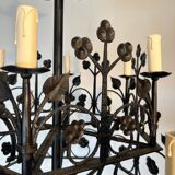 Lustre with 12 lights in wrought iron decorated with clovers and foliage.