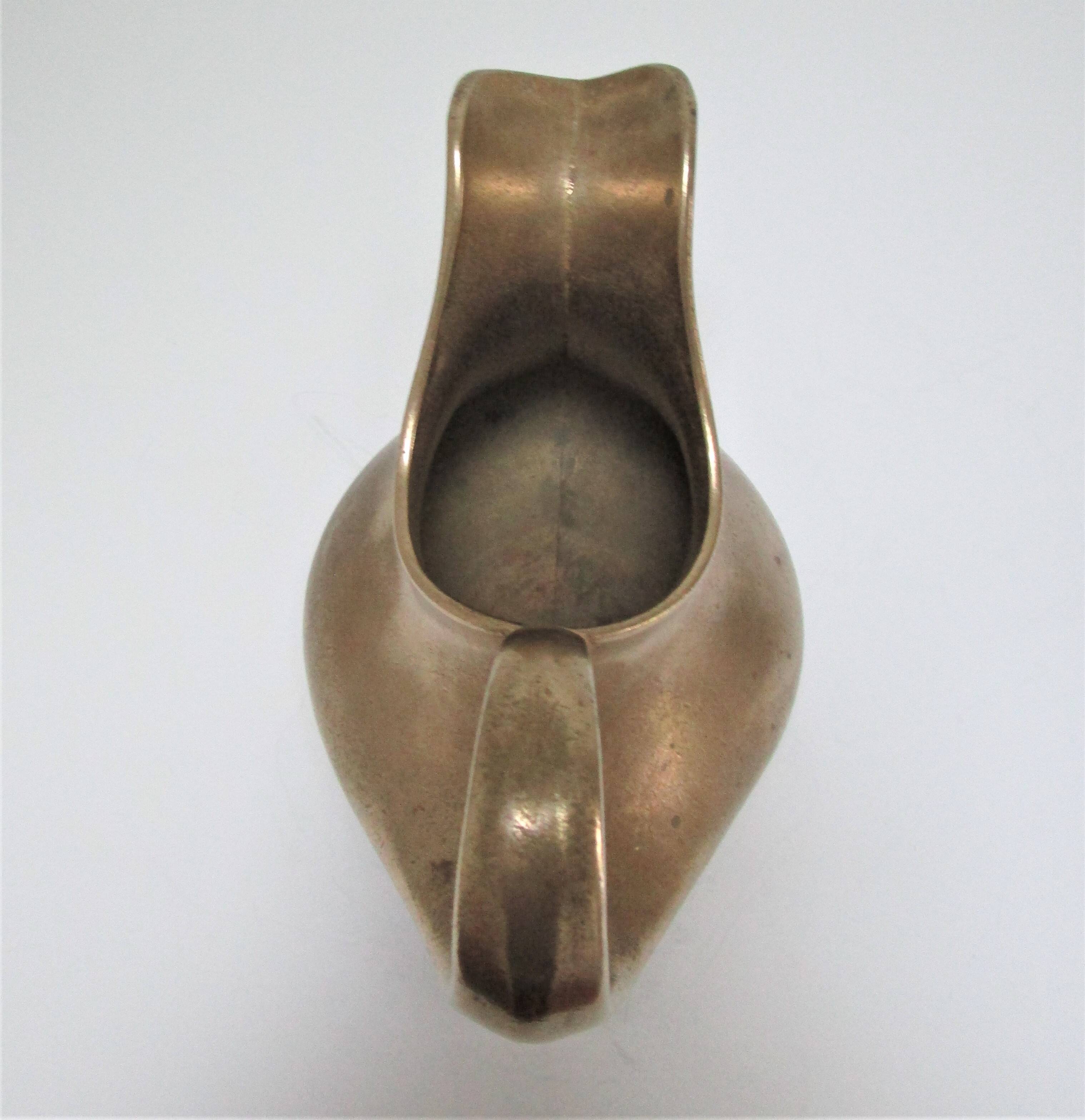 Stylized sculptural solid brass vase with handle