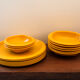 Service of vintage orange plastic plates 70s