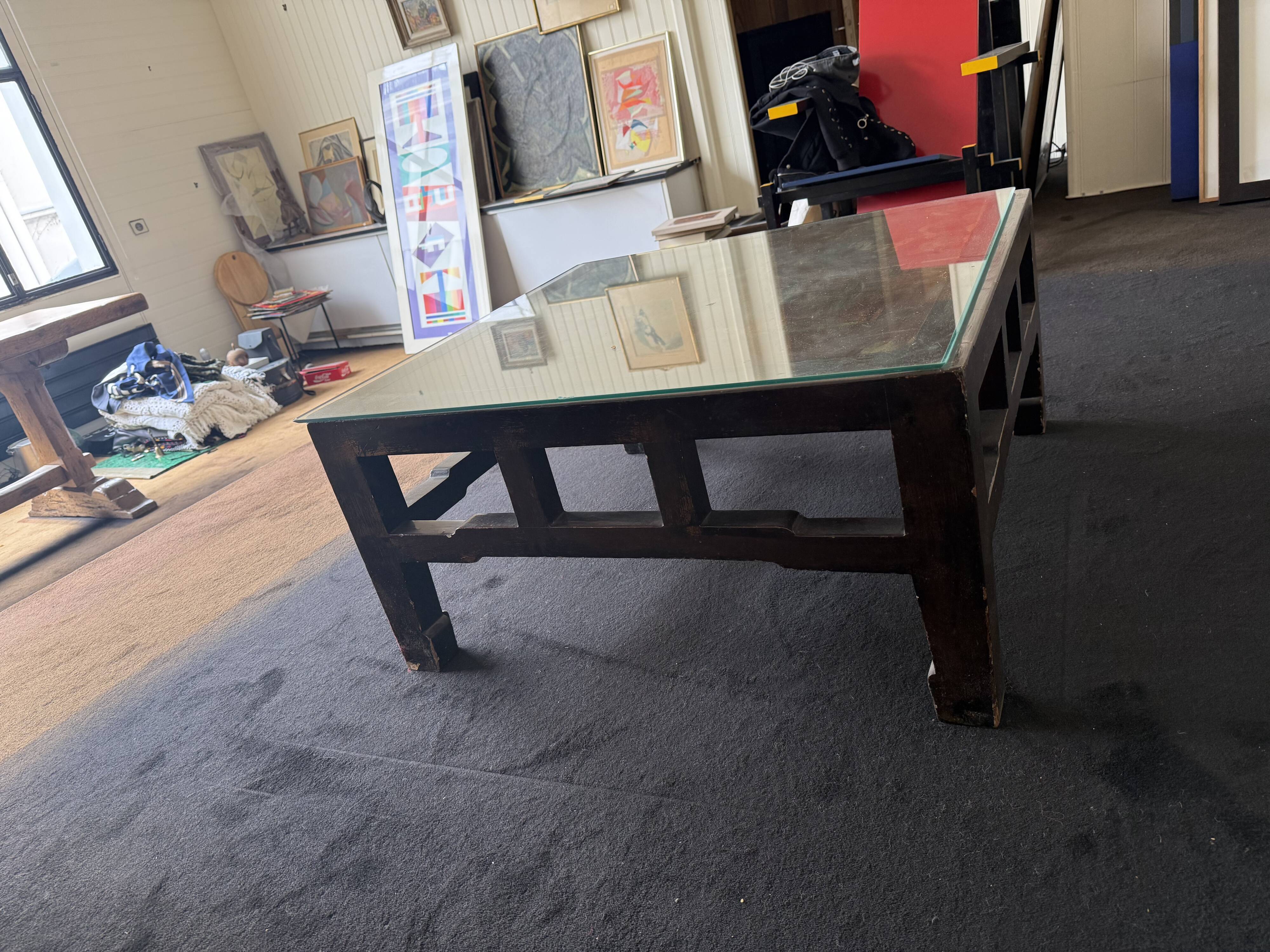Vintage brutalist coffee table with Asian decor.