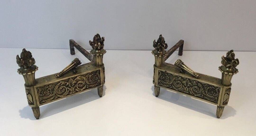 Pair of Empire Period Chenets in Chiselled Bronze with Torches and Leaf Frieze