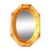 Small octagonal mirror in gilded leather.