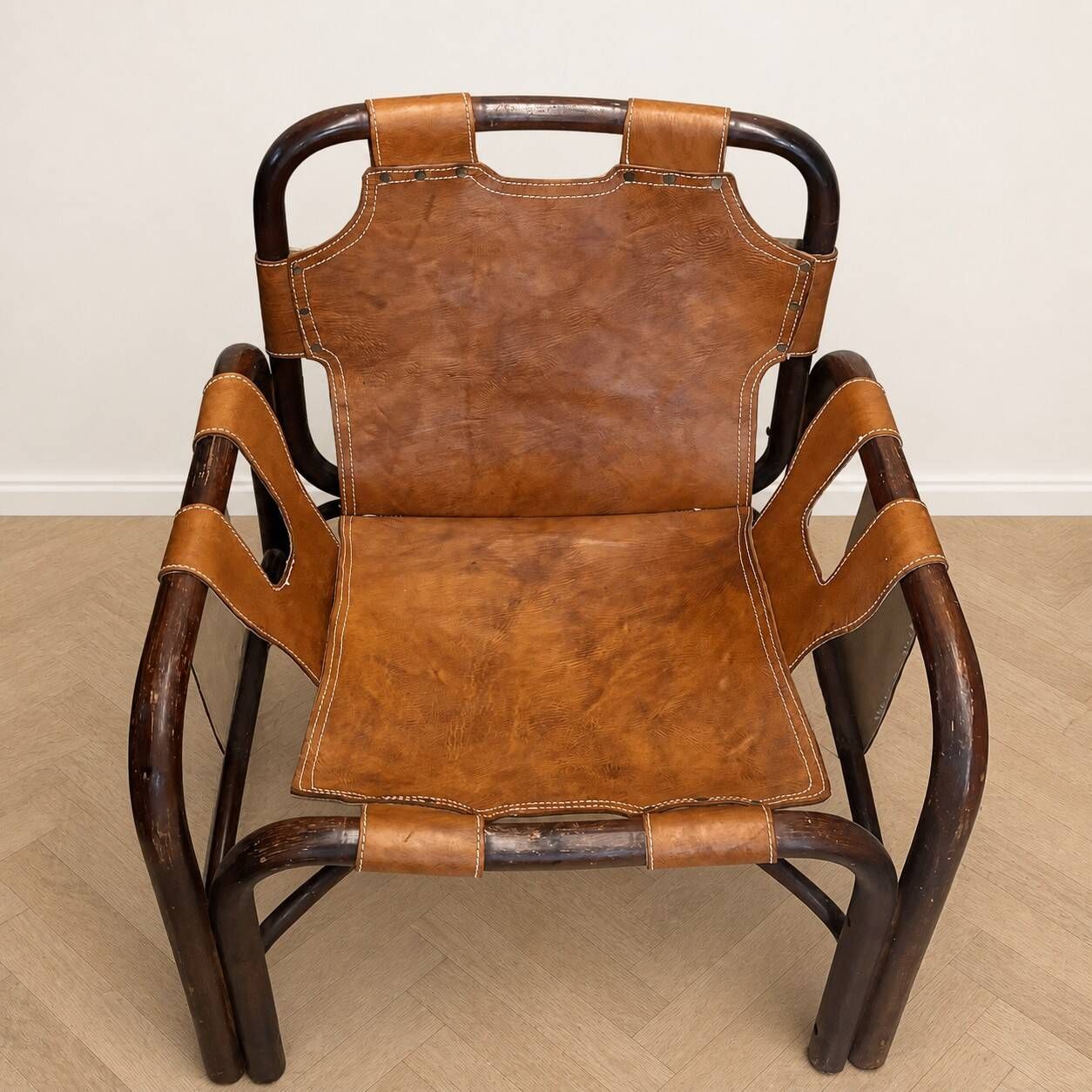 Pair of Tito Agnoli armchairs in leather and bamboo, 1970s.