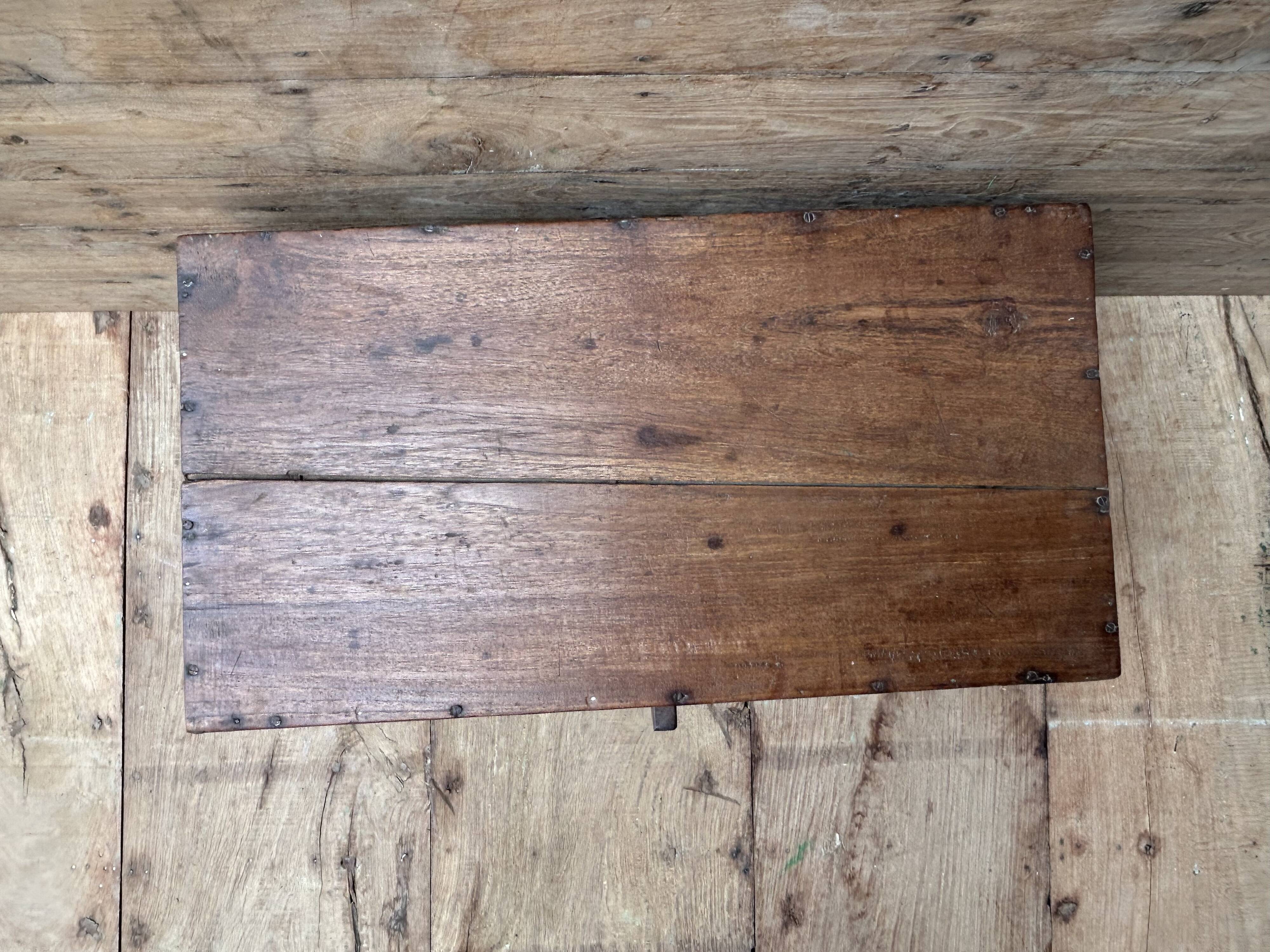 Teak chest from Burma with carved rosettes.