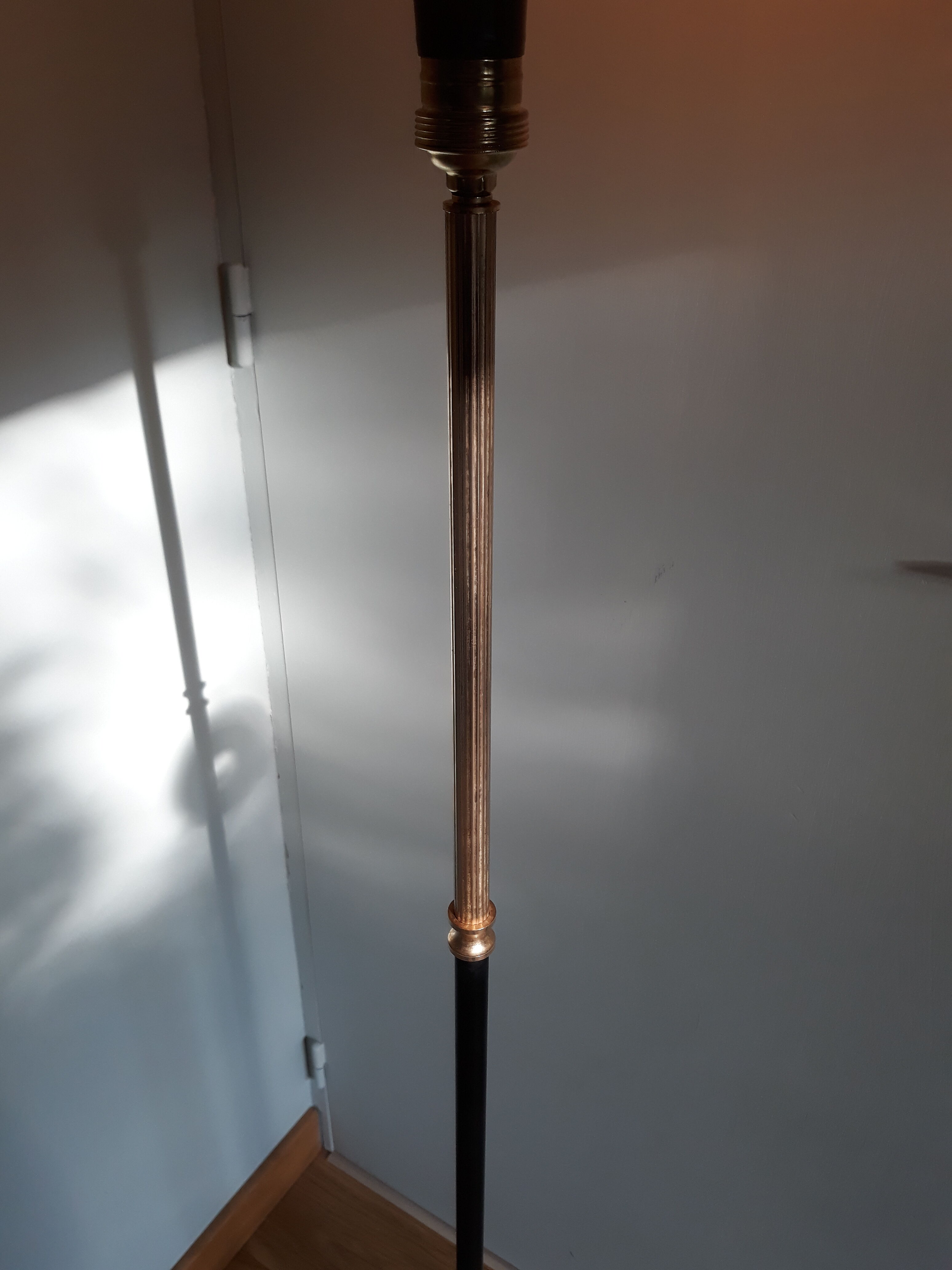 Golden and black tripod floor lamp