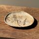 Small beige oval petrified wood dish or tray with crystals.
