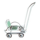 Old foldable stroller on metal wheels. Toy from the 50s