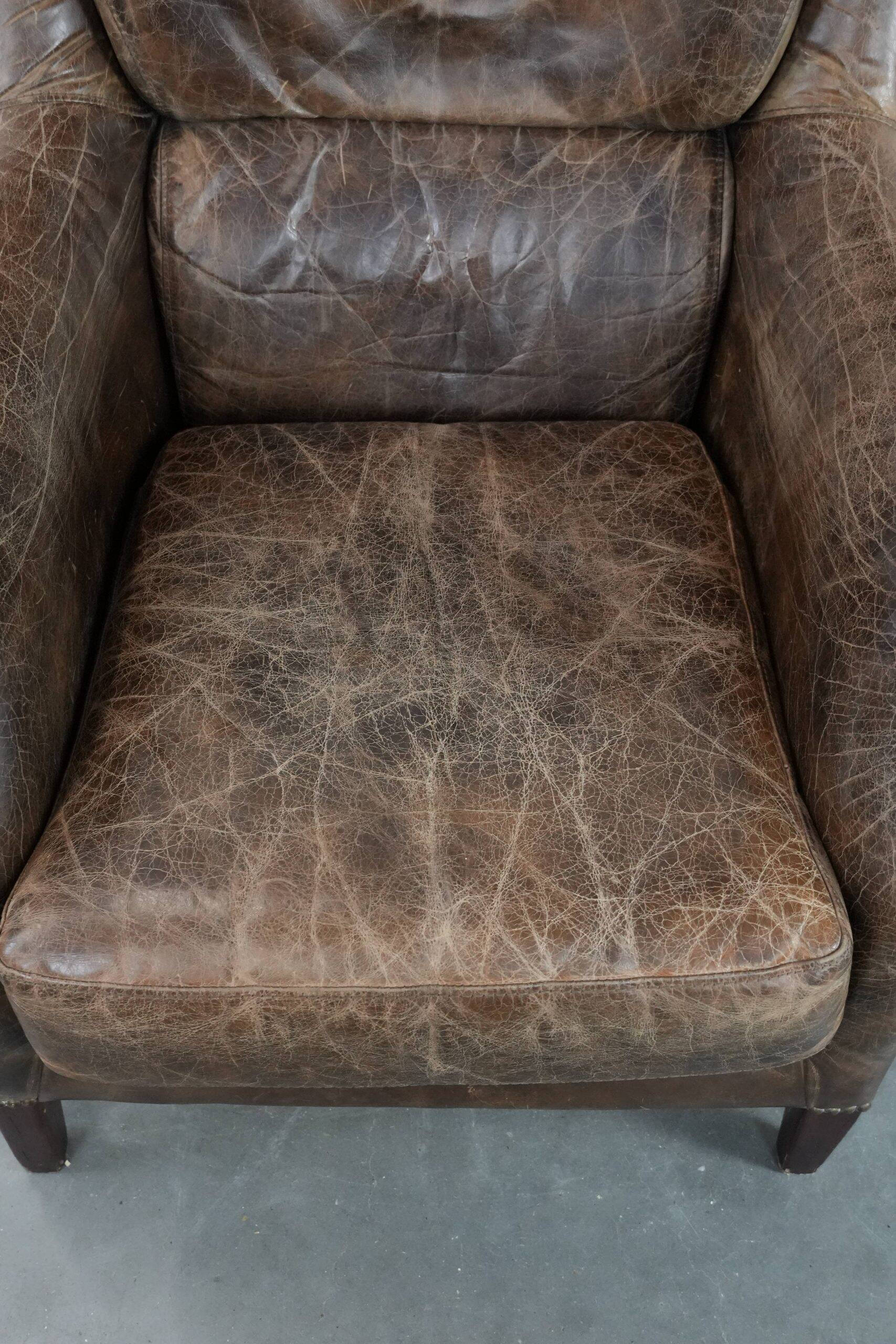 Very comfortable vintage cow leather armchair with beautiful colours