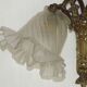 Double wall light in bronze in French Rococo style with white glass shades featuring patterns.