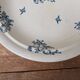 Shallow round plate Boch Frères model Regent with arabesque and foliage decoration.