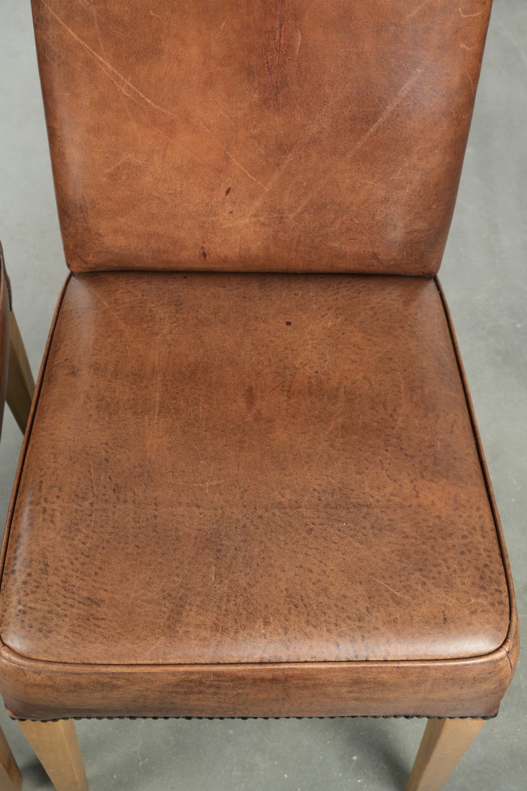 Set of 2 characterful dining chairs of sheepskin leather with a high back