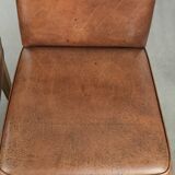 Set of 2 characterful dining chairs of sheepskin leather with a high back