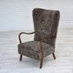 1960s, reupholstered Danish armchair, with stool, genuine sheepskin.