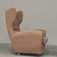 Beige wingback armchair and TVAR footrest, former Czechoslovakia.