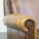Armchair made of sheep leather finished with decorative nails