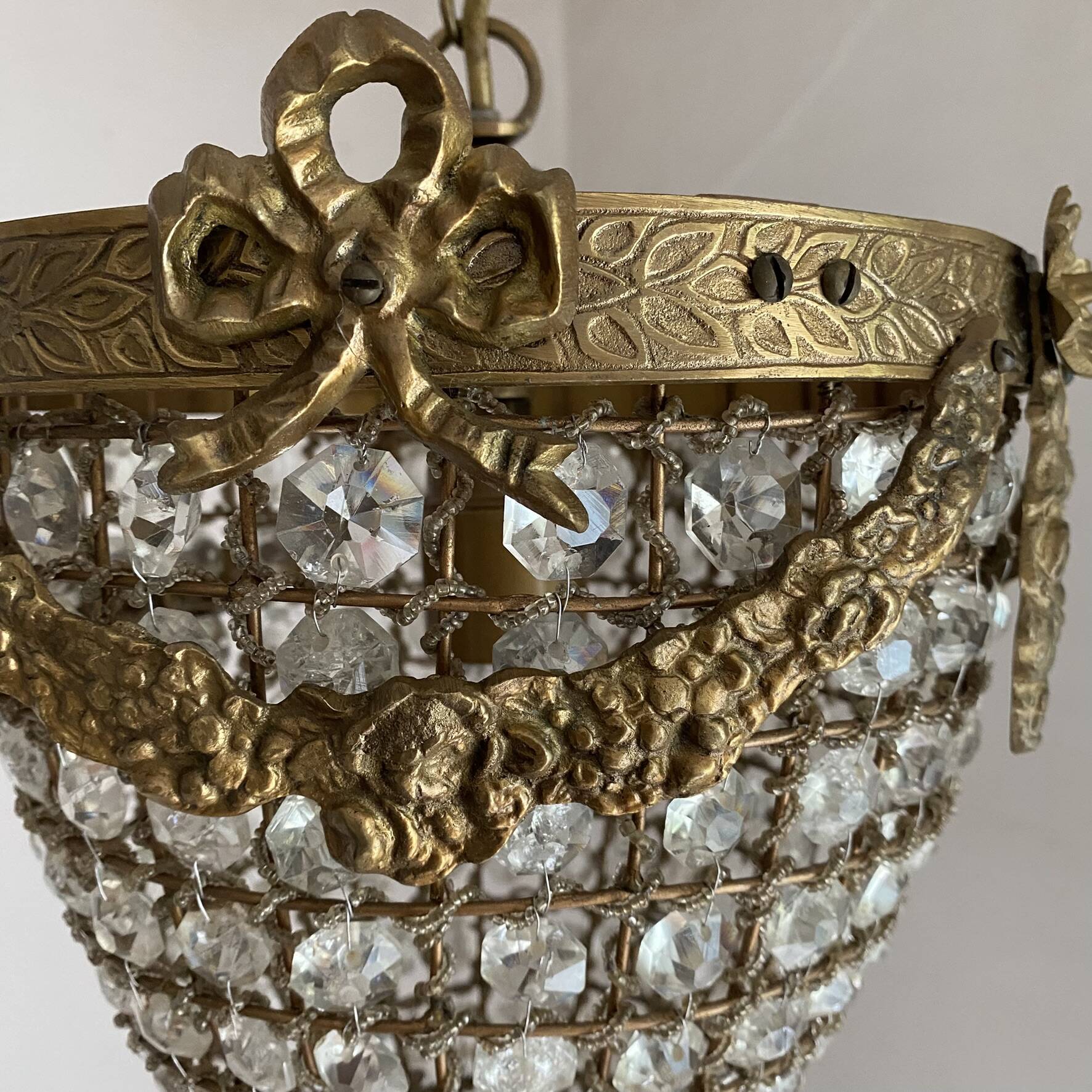 Brass basket chandelier with Louis XVI style pendants.