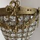 Brass basket chandelier with Louis XVI style pendants.