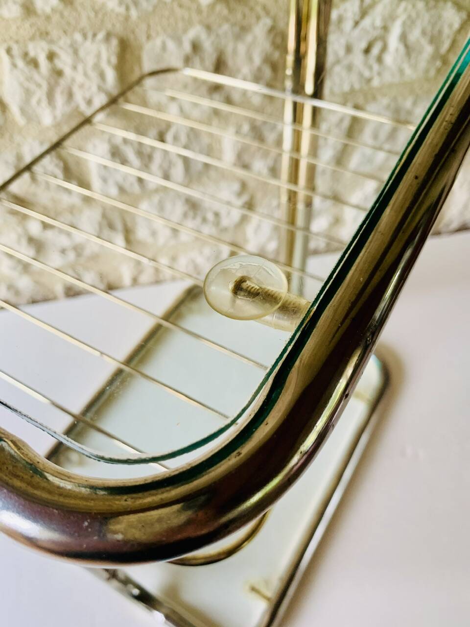 Glass and brass side table with magazine rack, circa 1970's