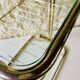 Glass and brass side table with magazine rack, circa 1970's