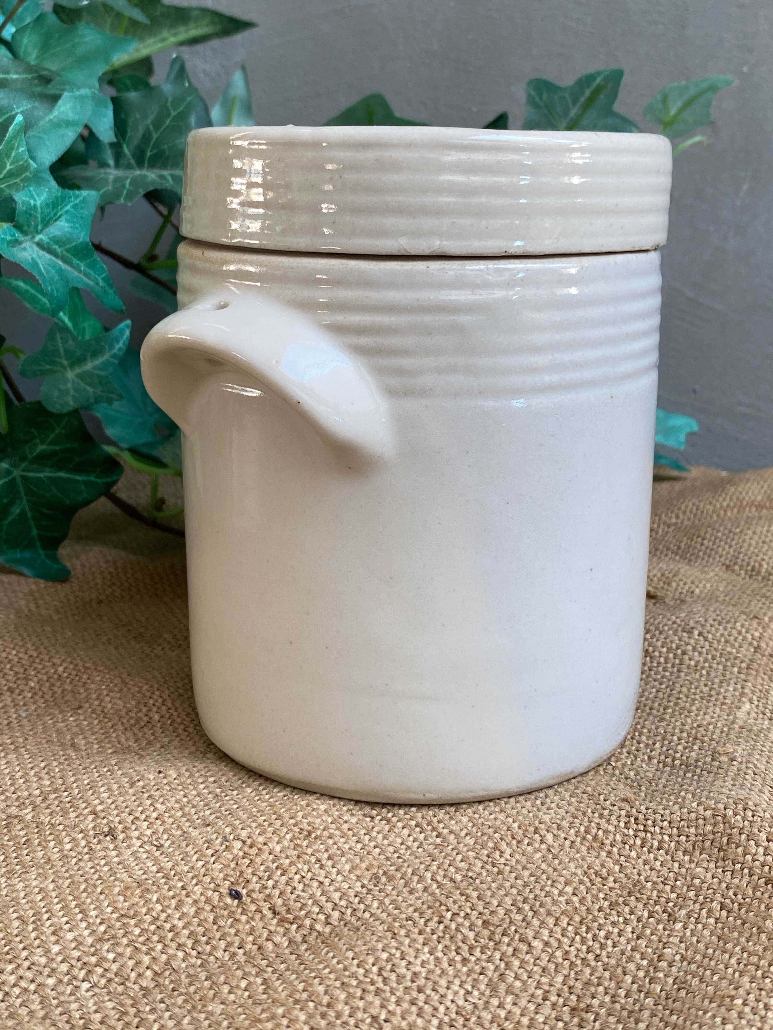 White pot in glazed earth