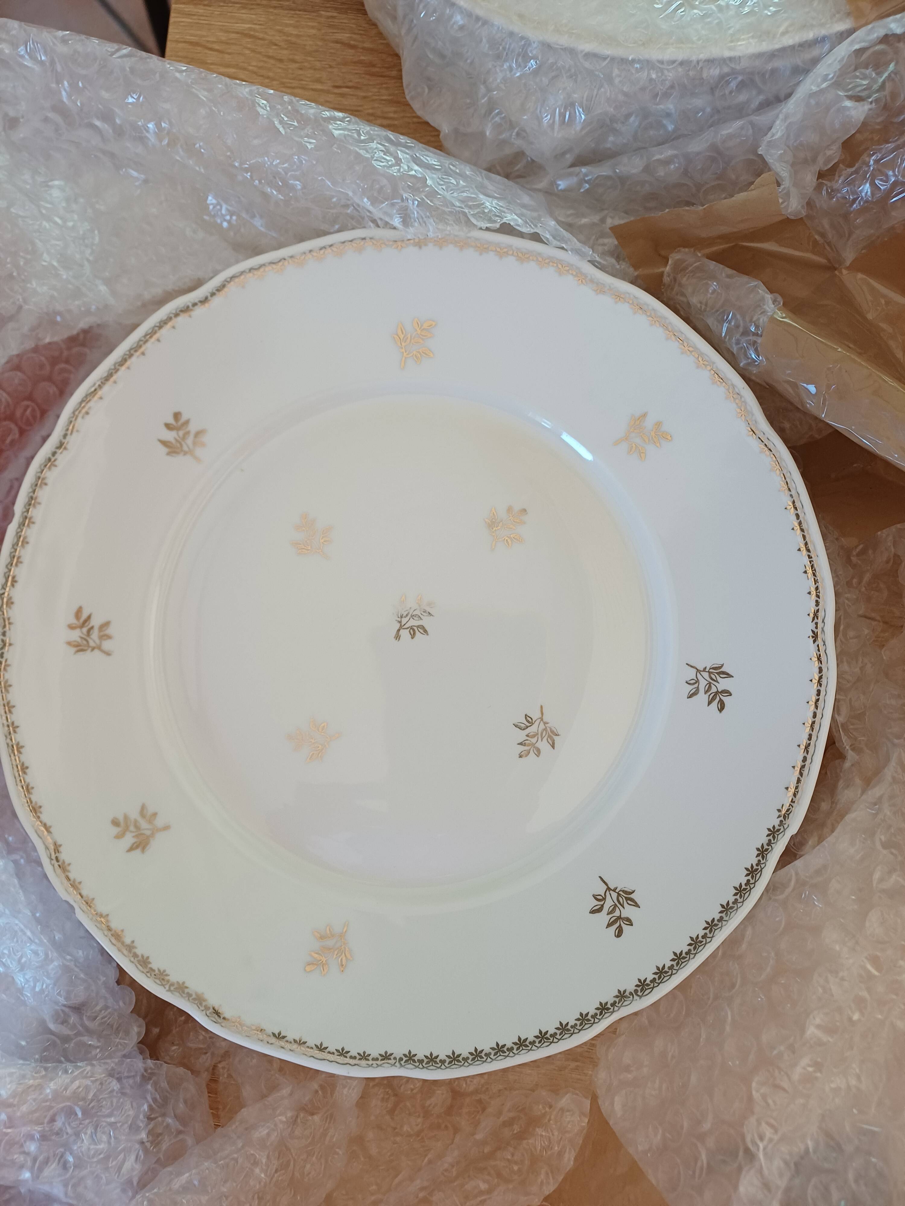 A lot of old white and gold porcelain plates T de F.