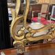 Mirror with carved and gilded wooden frame, 18th century, with scrollwork decoration.