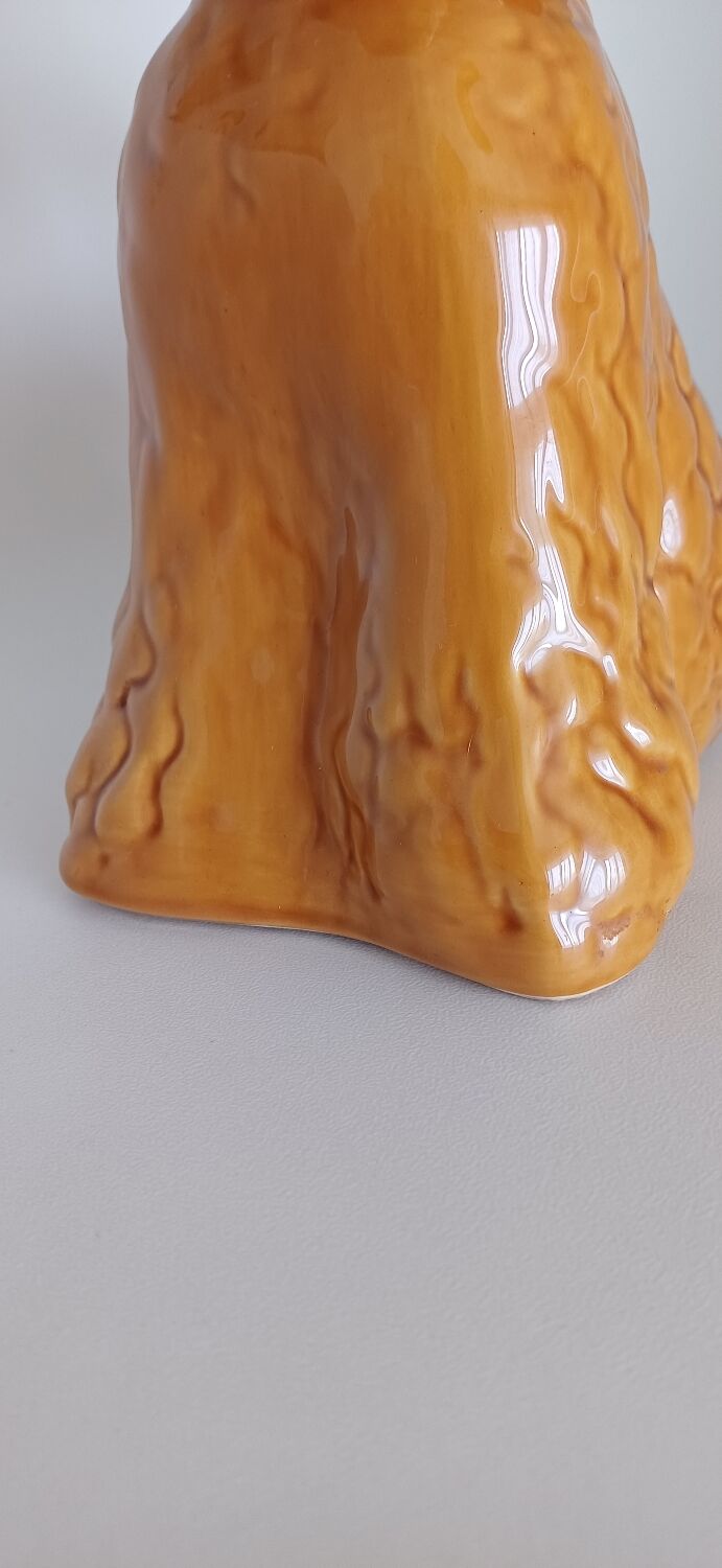 Ancient ceramic pitcher in the shape of a poodle.