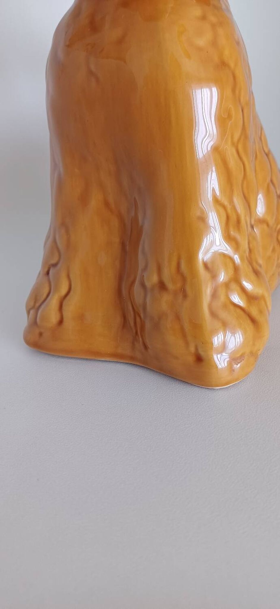 Ancient ceramic pitcher in the shape of a poodle.