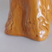 Ancient ceramic pitcher in the shape of a poodle.